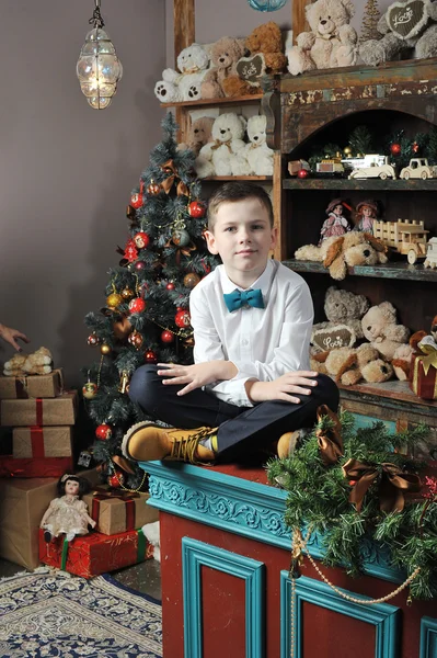 Christmas boy around Christmas tree with gifts — Stock Photo, Image