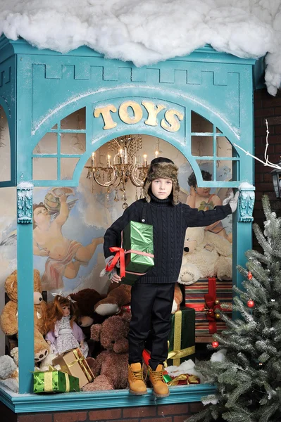 Christmas boy around Christmas tree with gifts — Stock Photo, Image