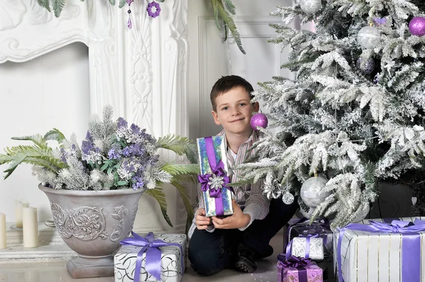 Christmas boy around Christmas tree with gifts — Stock Photo, Image