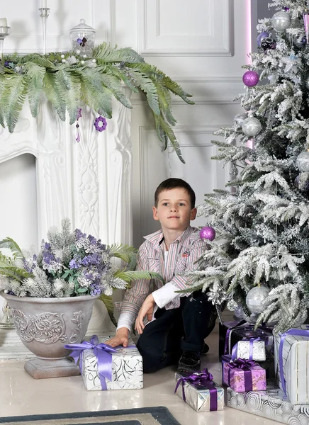 Christmas boy around Christmas tree with gifts — Stock Photo, Image