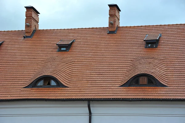 Черепичная крыша замка с окнами — стоковое фото