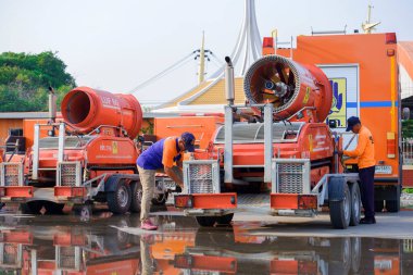 Samutsakhon, Tayland - 20 Kasım 2020: Afet önleme ve hafifletme departmanının saha çalışanları, kamu alanındaki toz azaltma görevi sonrasında itfaiye robotlarını itfaiye aracına taşıdılar