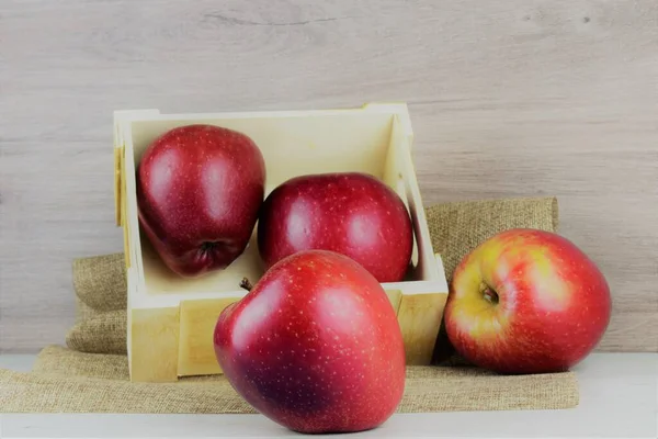 Close Red Apple Background Two Units Small Wooden Box Light — Stock Photo, Image