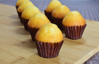 Tahta bir tabanda taze pişmiş küçük kekler..