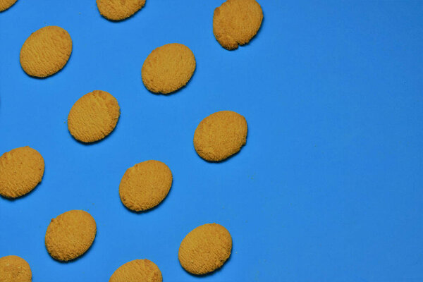 Wheat flour cookies on blue background