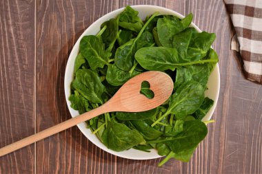 Zenith manzarası. Beyaz bir kâse içinde taze ıspanak yaprakları..