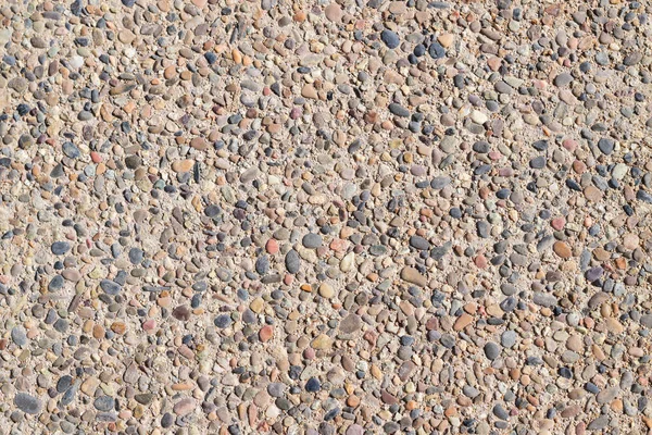 Arka plan, küçük taşlarla, çeşitli renk tonlarıyla. Uzayı kopyala Üst görünüm.