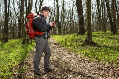 Adam uzun yürüyüşe çıkan kimse alarak fotoğraf ormandaki akıllı telefon ile