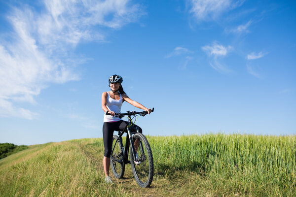 girl rides a bicycle in the countryside