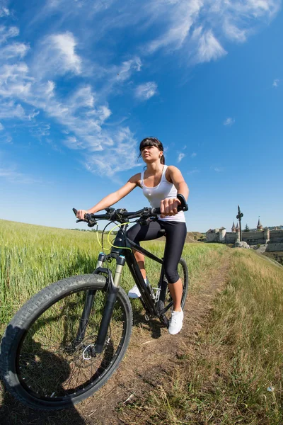 Mountain biking happy sportive girl relax in meadows sunny countryside