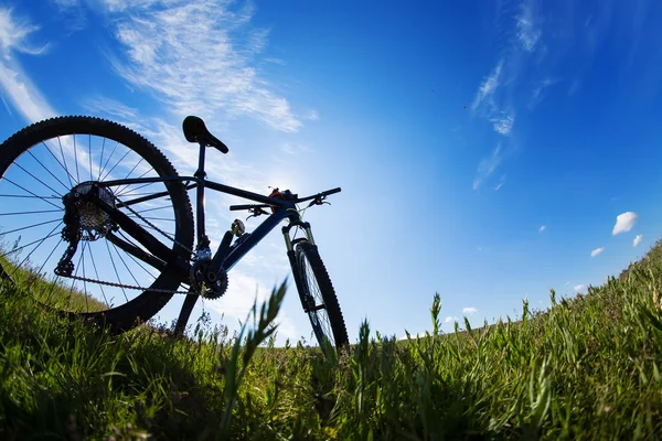 Fiets in weide tijdens zonsondergang — Stockfoto