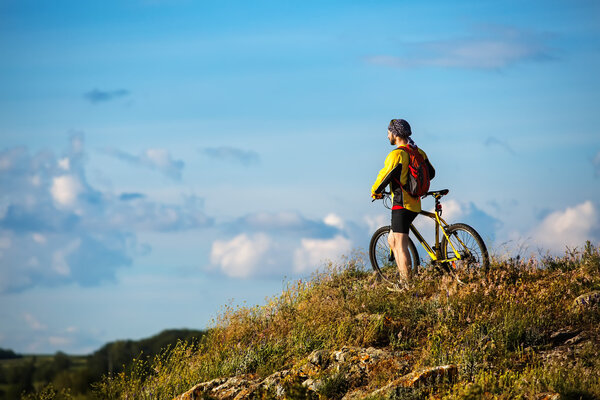 Young man cycling on a rural road