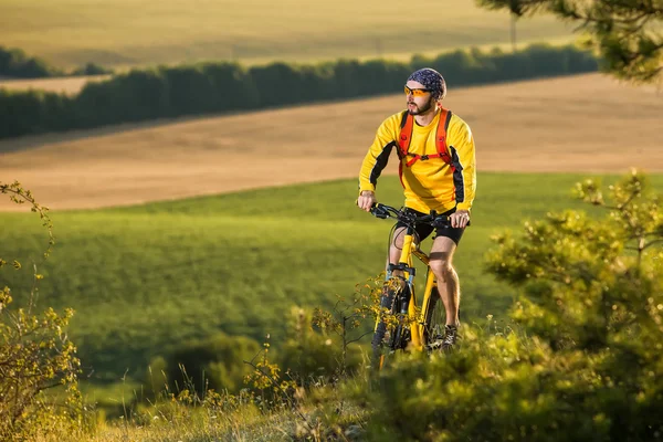 Joven ciclismo en una carretera rural — Foto de Stock