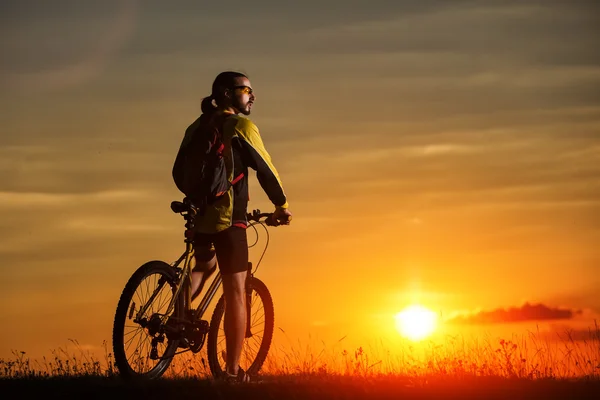 Sporty Man in sella a una bicicletta sulla strada di campagna . — Foto Stock