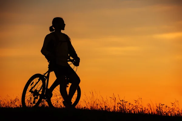 Silhouette of a bike on sky background during sunset — Stock Photo, Image