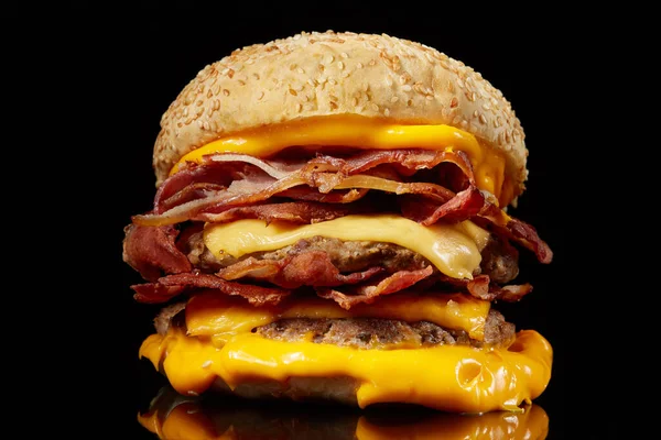 Burger with meat and cheese on black background. — Stock Photo, Image