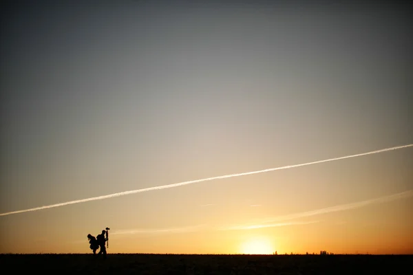 Silhouette of a photographer during the sunset. — Stock Photo, Image