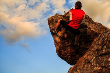 Kayaya tırmanma adam. Genç yerleştirmek, güçlü erkek dağcı
