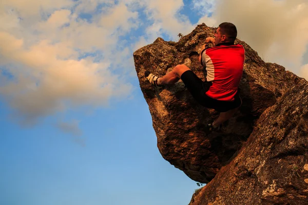 Hombre subiendo a la roca. Joven en forma, fuerte escalador masculino —  Fotos de Stock