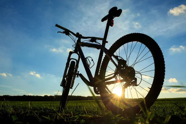 夕暮れ時の山の自転車のシルエット — ストック写真