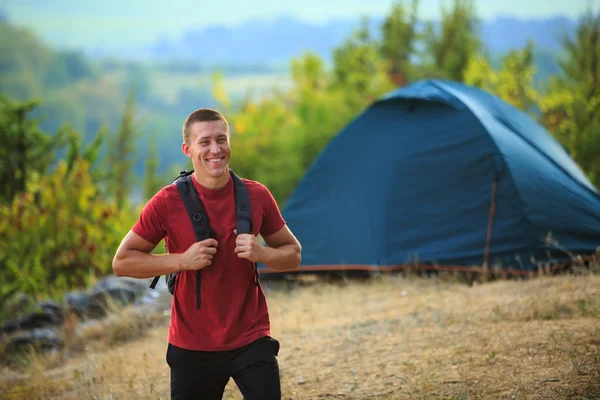 Glücklicher junger Mann Backpacker in den sommerlichen Bergen — Stockfoto