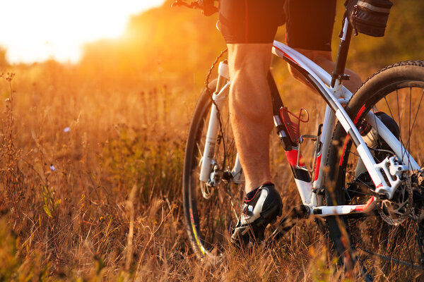 cyclist man legs riding mountain bike on outdoor trail