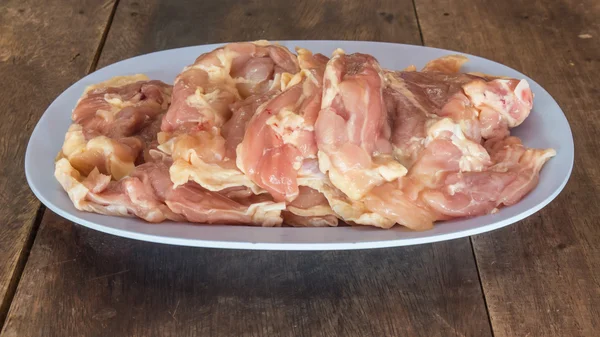 Pedaço de carne crua de frango na mesa de madeira . — Fotografia de Stock