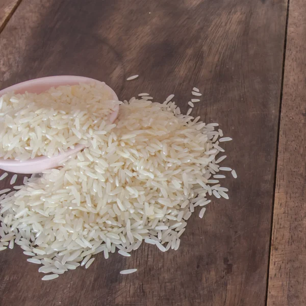 Polished rice in cup on the wooden table — Stock Photo, Image