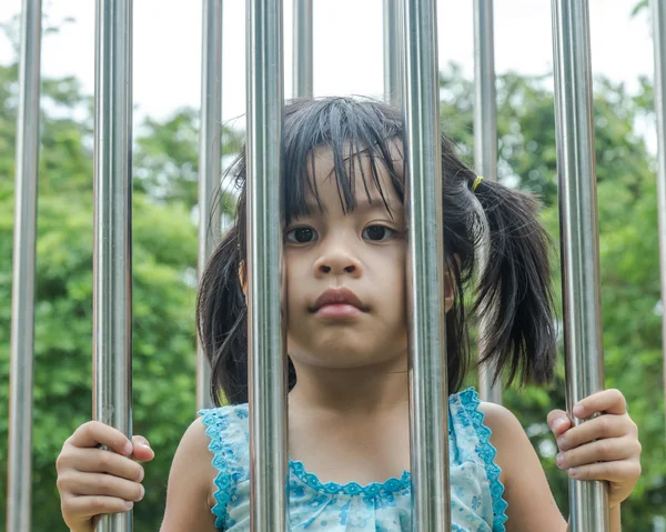 Girls in cages, stainless steel made a sad face. — Stock Photo, Image