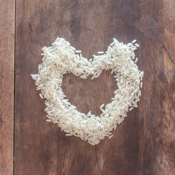 Corazón arroz pulido en la mesa de madera . —  Fotos de Stock