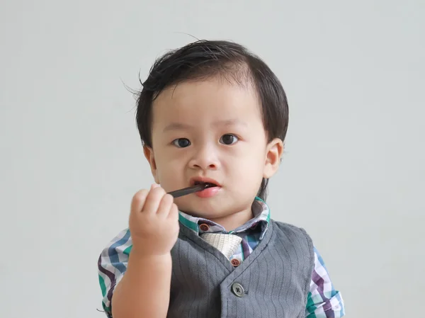 Boy bites pencil on a shirt wear — Stock Photo, Image