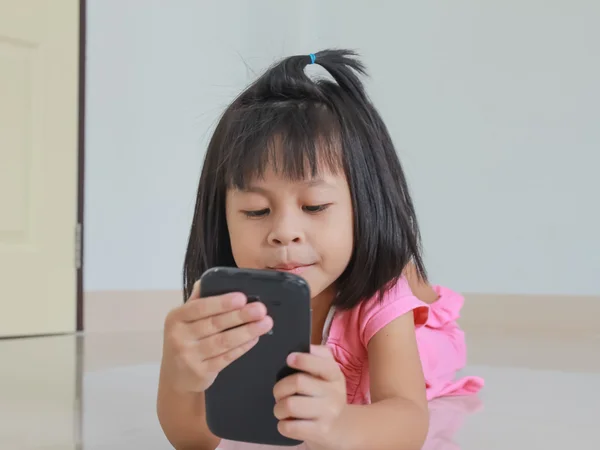 Curious baby toddler exploring mobile phone — Stock Photo, Image