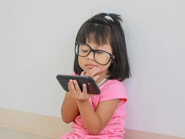 Curious baby toddler exploring mobile phone — Stock Photo, Image