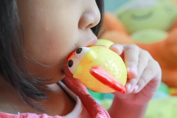 Girl are blown chicken toy with sound. — Stock Photo, Image