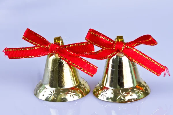 Two christmas bells with red ribbon. Royalty Free Stock Images