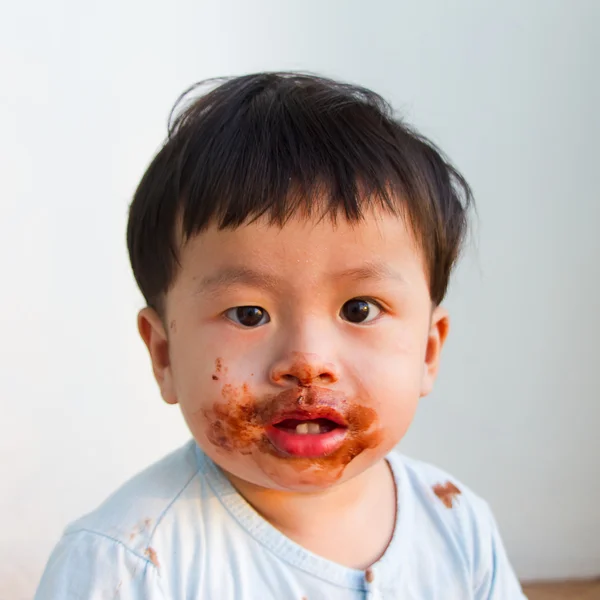 Asia chłopiec jeść czekolady — Zdjęcie stockowe