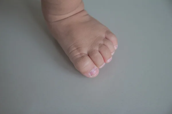 Foot of a little feet on white background — Stock Photo, Image