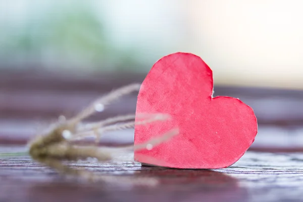Red heart and blur flower grass on wood — Stock Photo, Image