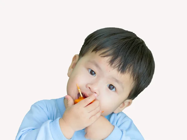 Portrait asian boy eating papaya on wood tip. — Stock Photo, Image