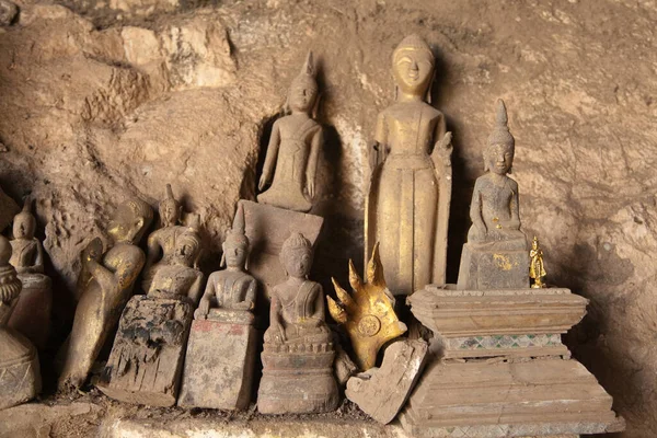 Ou Pak Caves Laos with small and miniature Buddha statues in many different pose