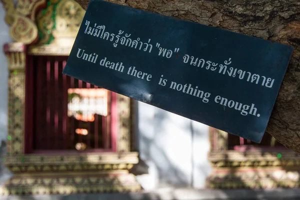 Until Death There Is Nothing saying by Buddha on sign temple garden Chiang Mai