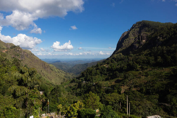 Ella Sri Lanka mountain gap landscape against blue skies with clouds Adams Peak