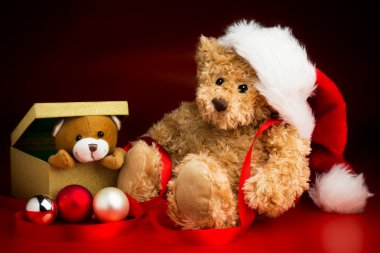 Teddy Bear Wearing a Christmas Hat and a Toy Bear Peeking Out of clipart
