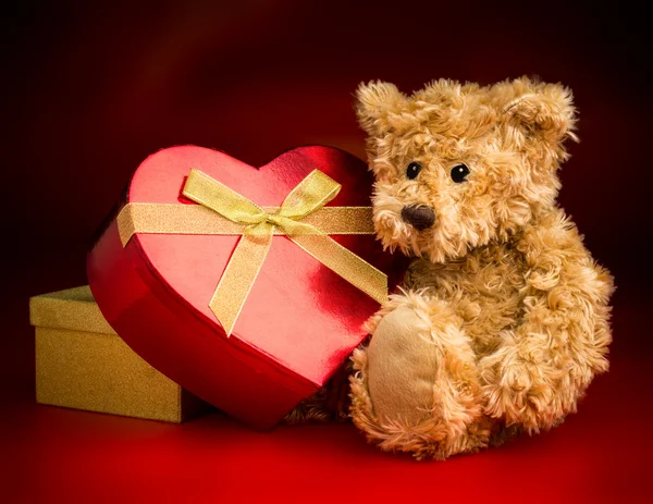 A Teddy Bear Hugging a Heart Shaped Box — Stock Photo, Image