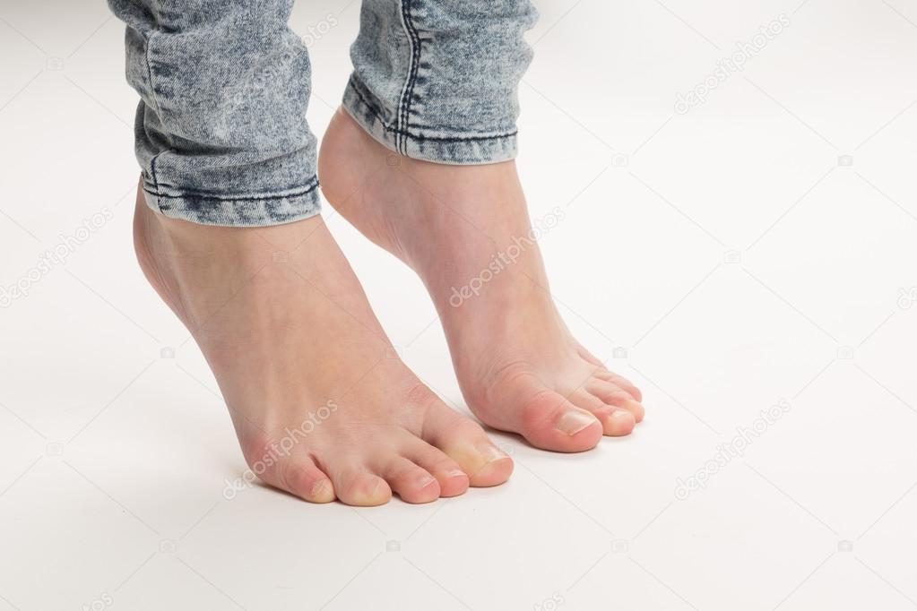 Two Bare Feet Standing TipToe On The Floor
