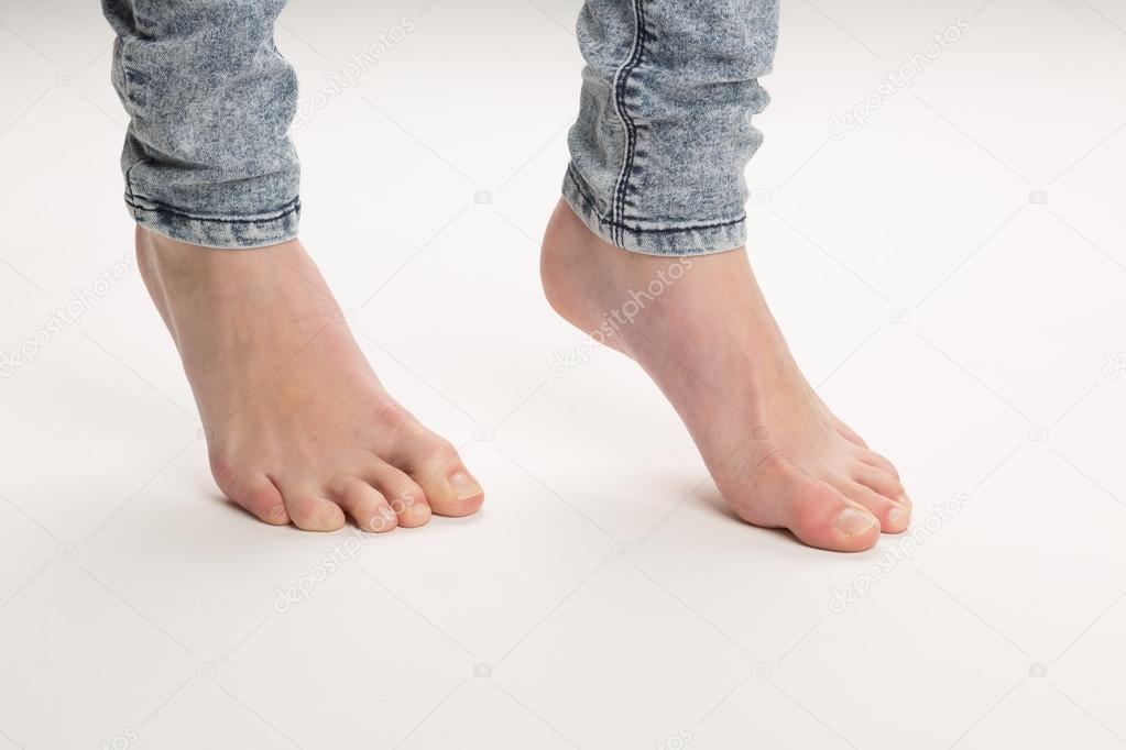 Two Bare Feet Standing TipToe On The Floor
