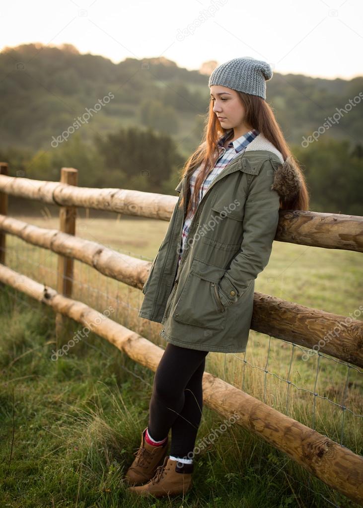 Beautiful Teen Girl Leaning Against A Farm Fence