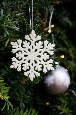 Kar tanesi şekli, arka planda noel ağacı topu ile yakın plan 