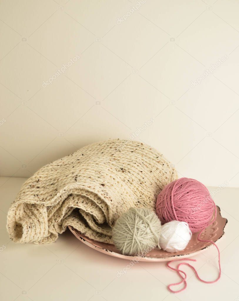 pink and white woolen balls with woolen scarf