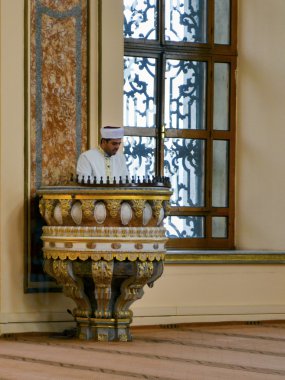 Dolmabahce Mosque imam preaching in the pulpit. Television vide clipart